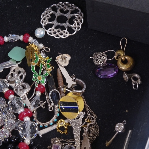 888 - A case containing bead necklaces, including jade, coral etc