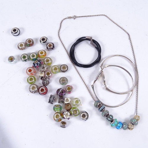 898 - A collection of coloured silver mounted charms, 2 silver and mother-of-pearl bangles etc