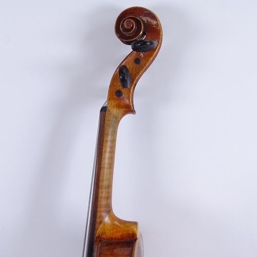 311 - An early/mid-20th century Stradivarius copy violin and bow, in hardshell case, violin length 60cm