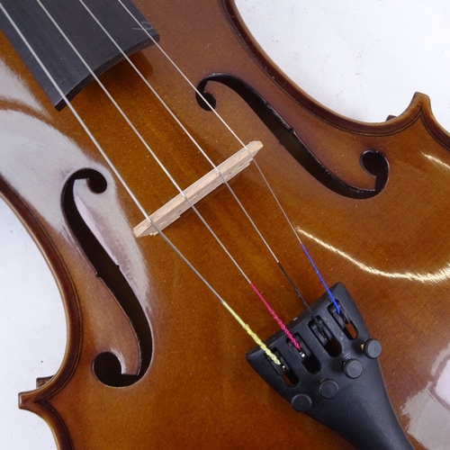 712 - A violin and bow in case