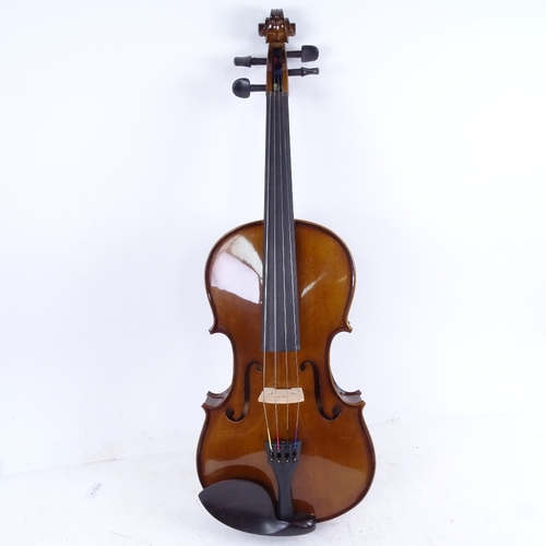 712 - A violin and bow in case