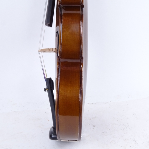 712 - A violin and bow in case