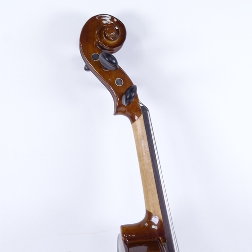 712 - A violin and bow in case