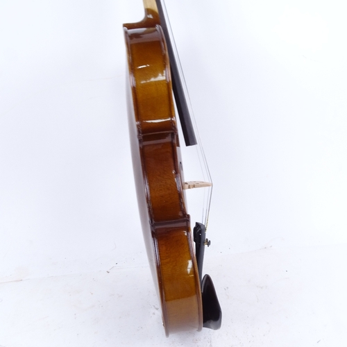 712 - A violin and bow in case