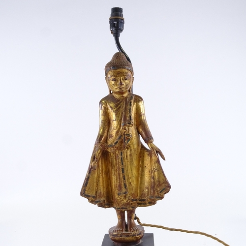 123 - A carved giltwood standing Buddha figural table lamp, height to top of head 49cm, PAT tested