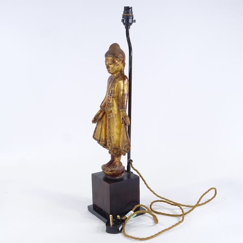 123 - A carved giltwood standing Buddha figural table lamp, height to top of head 49cm, PAT tested