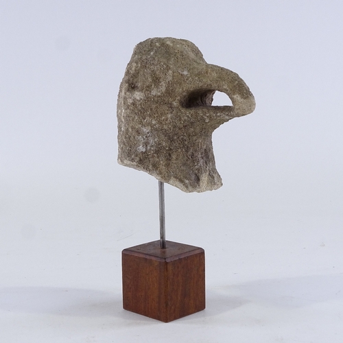 124 - A carved stone eagle's head mounted on wood stand, overall height 25cm