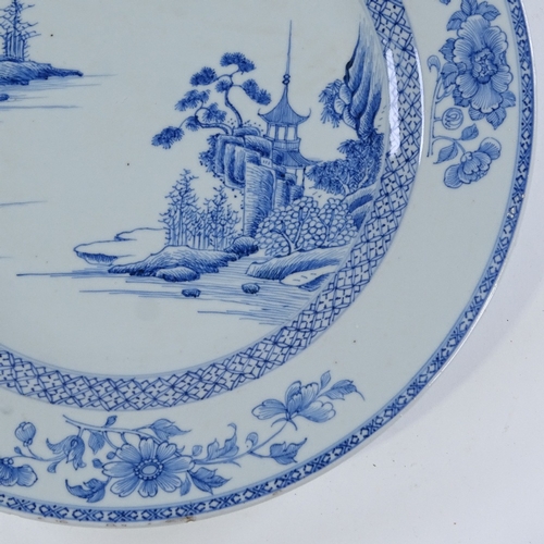 128 - A Chinese blue and white porcelain charger, hand painted landscape designs, diameter 35cm