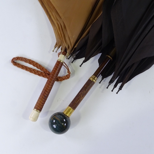 148 - A Vintage parasol with agate ball handle stamped Brigg, and a leather and ivory-handled parasol (2)