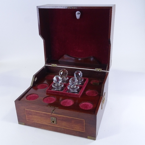 151 - A large brass-bound mahogany campaign decanter box, containing 4 original square cut-glass decanters... 