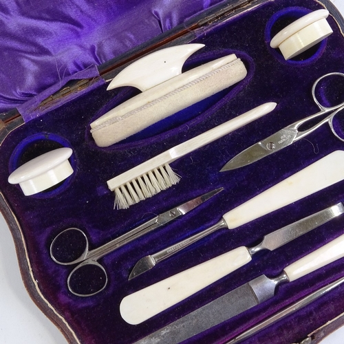 154 - A leather-cased ivory manicure set, and another manicure case (2)