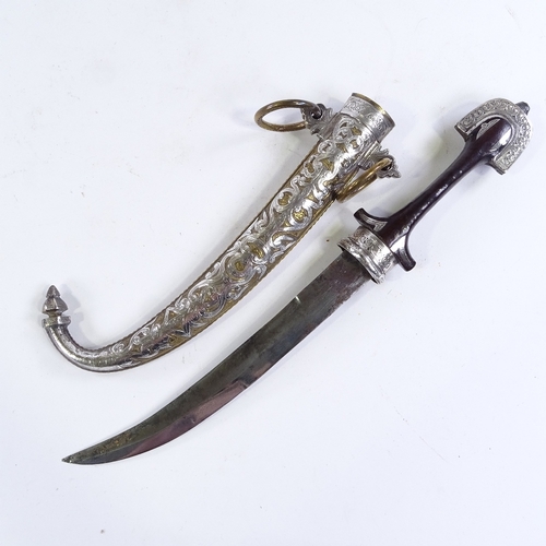 163 - A 19th century Middle Eastern jambiya knife, silver-mounted carved wood hilt, with original brass an... 