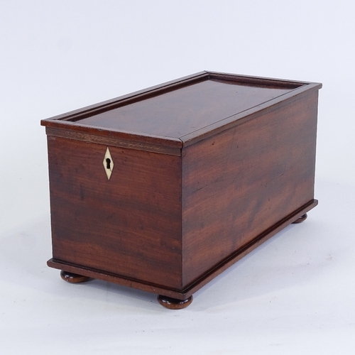 164 - A Georgian flame mahogany box, with sliding locking lid and bun feet, 35cm x 17.5cm x 18cm