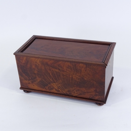 164 - A Georgian flame mahogany box, with sliding locking lid and bun feet, 35cm x 17.5cm x 18cm