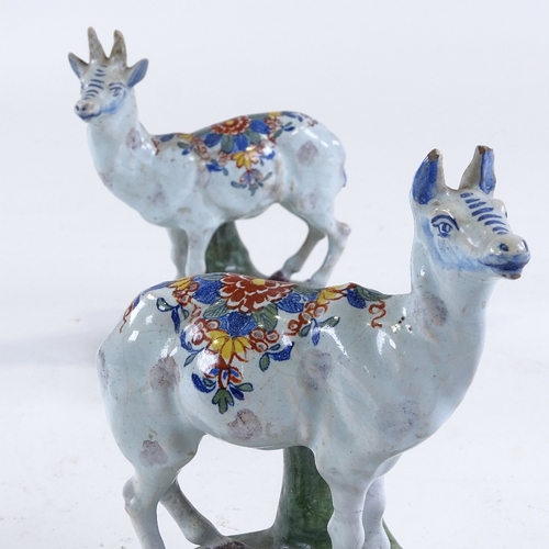 180 - A pair of Dutch Delft tin glaze pottery stag and doe ornaments, height 15cm