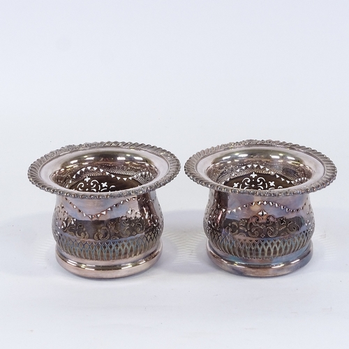 193 - A pair of silver plate on copper wine coasters, with cast gadrooned borders, 18cm across