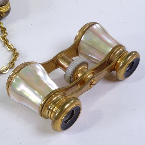 210 - A pair of mother-of-pearl and gilt-metal opera glasses, in original leather carrying case with gilt-... 