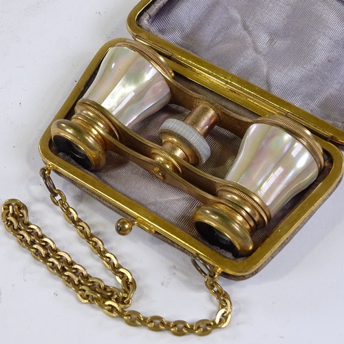 210 - A pair of mother-of-pearl and gilt-metal opera glasses, in original leather carrying case with gilt-... 