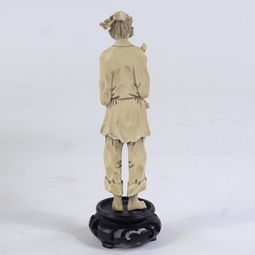 232 - A Japanese carved ivory fisherman, Meiji Period, circa 1900 to 1920, on wooden stand, overall height... 