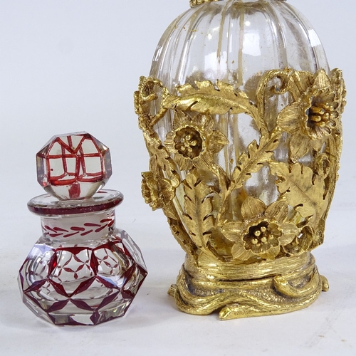 261 - An ornate gilt-metal and glass perfume bottle, height 12.5cm, and 3 smaller glass perfume bottles (i... 