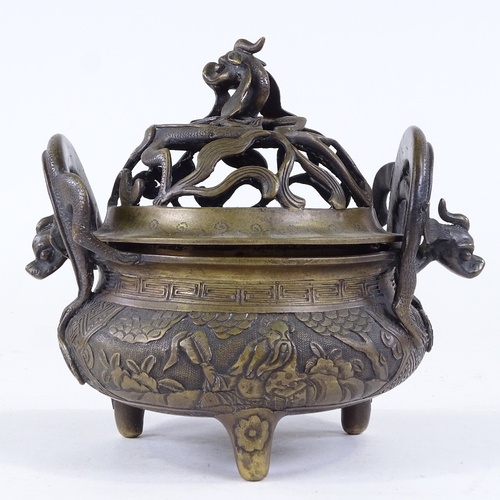 272 - A Chinese cast-bronze incense burner, with pierced dragon decorated cover, cast dragon handles, and ... 