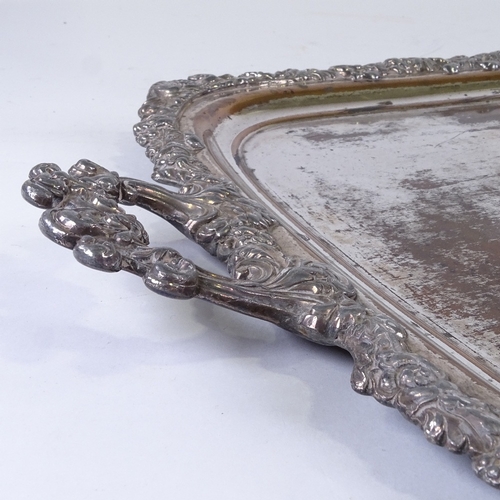 285 - A mid-19th century Sheffield plate tea tray, with armorial crest and cast surround, length excluding... 