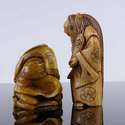 294 - 2 Japanese carved stained ivory netsuke, 1 with a rotating face, height 5cm (2)