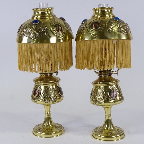 310 - A pair of Victorian brass oil lamps, with relief embossed decoration, inset printed portrait plaques... 