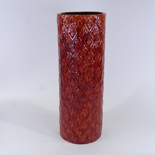 313 - Burmantofts, red treacle glaze relief moulded stick stand, height 60cm, diameter 21cm