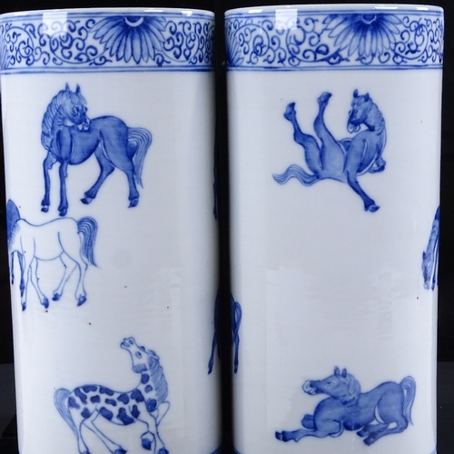 321 - A pair of Chinese blue and white porcelain cylinder vases, with painted horses, height 28cm, diamete... 