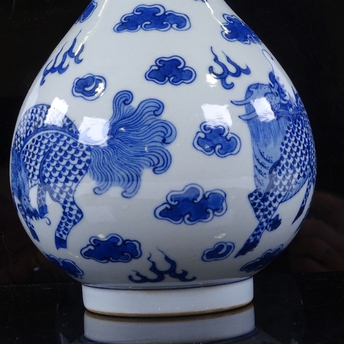 322 - A Chinese blue and white porcelain dragon design narrow-neck vase, 4 character mark, height 26cm