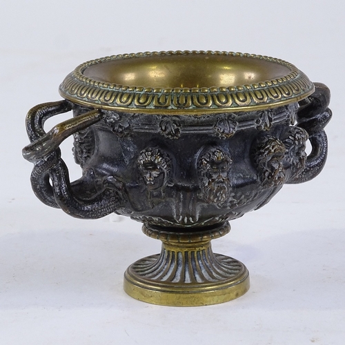 332 - A small 19th century patinated bronze Classical urn, the frieze decorated with masks, rim diameter 9... 