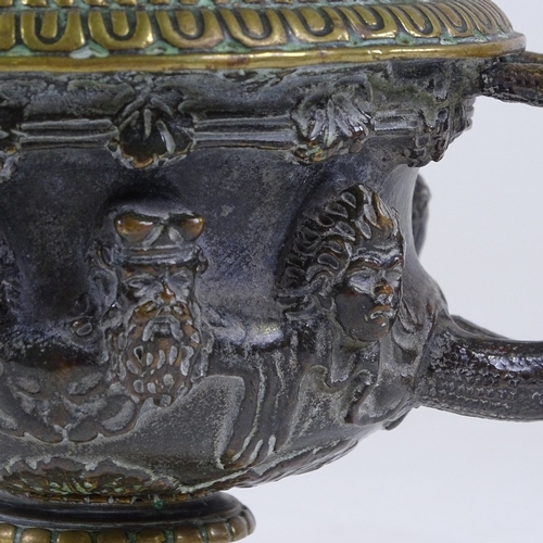 332 - A small 19th century patinated bronze Classical urn, the frieze decorated with masks, rim diameter 9... 