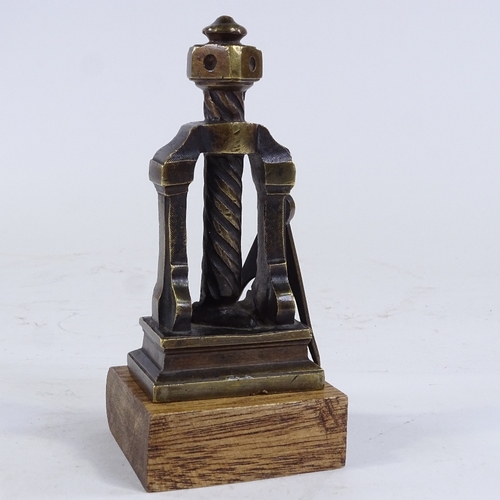 336 - A patinated bronze desk paperweight in the form of a book press, on wood plinth, height 15cm