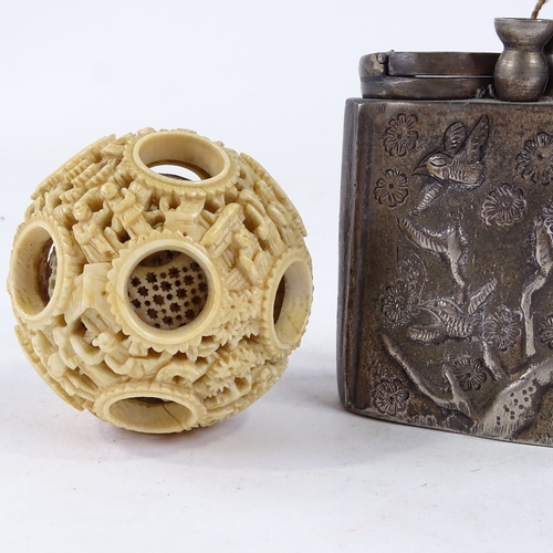 347 - A Chinese ivory puzzle ball, an opium pipe, and a small jade pendant (3)