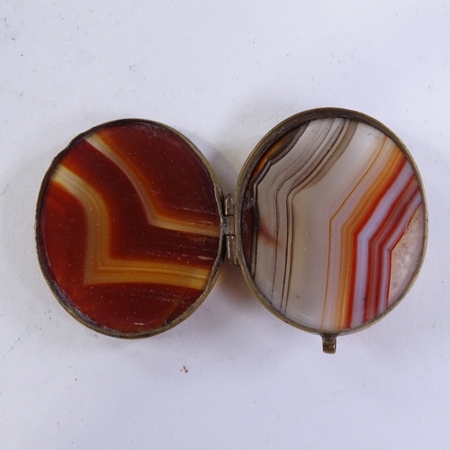 364 - A 19th century agate and brass snuffbox, length 6cm, and an agate and brass locket (2)