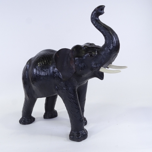 72 - A mid-20th century leather-covered elephant, thought to have been purchased at Liberty, overall leng... 