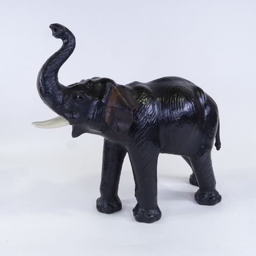 72 - A mid-20th century leather-covered elephant, thought to have been purchased at Liberty, overall leng... 