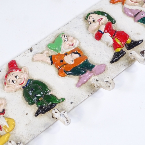 75 - A Walt Disney Seven Dwarfs design painted cast-iron coat rack, with relief moulded figures, probably... 