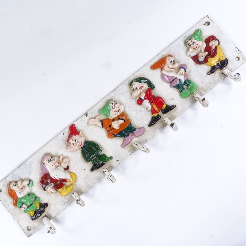 75 - A Walt Disney Seven Dwarfs design painted cast-iron coat rack, with relief moulded figures, probably... 