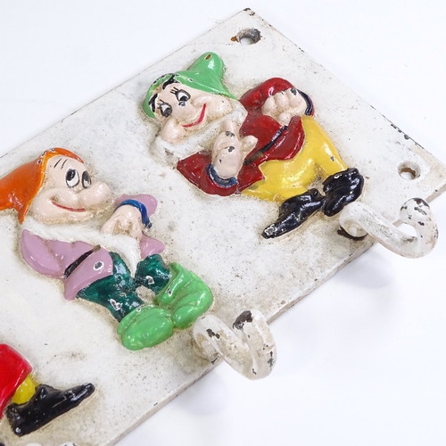 75 - A Walt Disney Seven Dwarfs design painted cast-iron coat rack, with relief moulded figures, probably... 