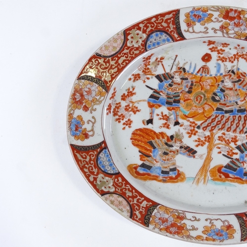 85 - A Japanese Imari style oval porcelain plate with painted Samurai Warriors, 6 character mark, 31.5cm ... 