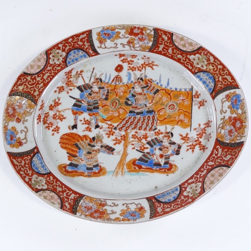 85 - A Japanese Imari style oval porcelain plate with painted Samurai Warriors, 6 character mark, 31.5cm ... 