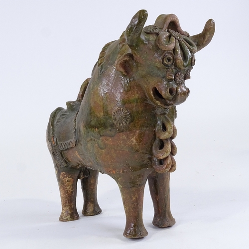 86 - Pucara Pottery (Peru), green treacle glaze terracotta wine flask in the form of a bull, length 33cm,... 