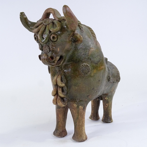 86 - Pucara Pottery (Peru), green treacle glaze terracotta wine flask in the form of a bull, length 33cm,... 