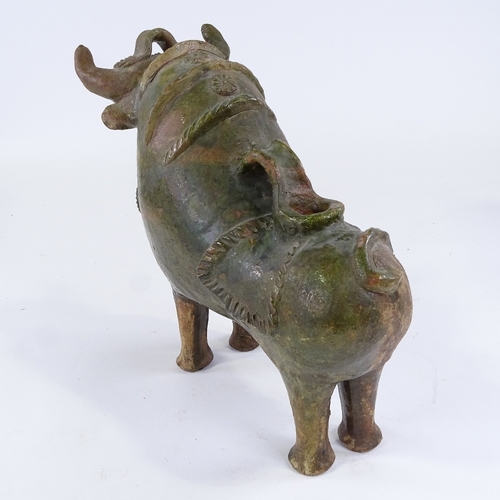 86 - Pucara Pottery (Peru), green treacle glaze terracotta wine flask in the form of a bull, length 33cm,... 