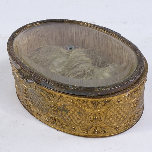 403 - A 19th century oval gilt-metal trinket box with bevel-glass panelled hinged lid, length 13.5cm