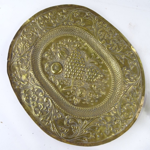 427 - An early relief embossed brass oval dish, 30cm across, a Scottish white metal snuff mull, and a cabo... 