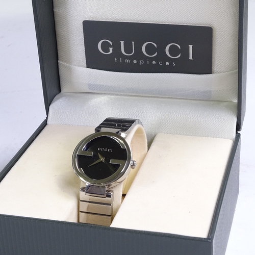 527 - GUCCI - a lady's stainless steel monogram quartz wristwatch, ref. 133.5, black dial with original Gu... 