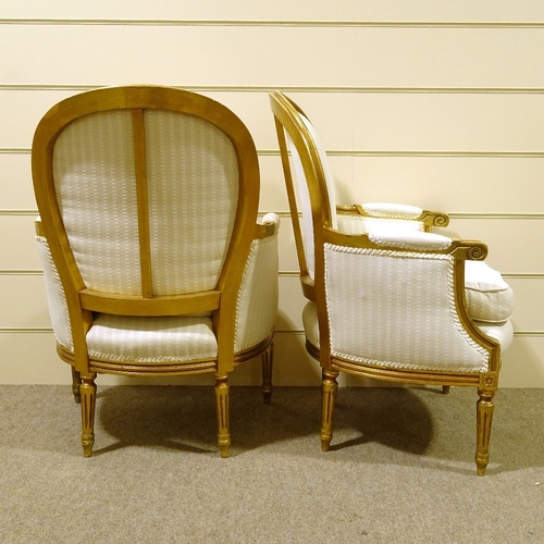 113 - A pair of French carved giltwood-framed salon armchairs, recently re-upholstered in pale striped fab... 